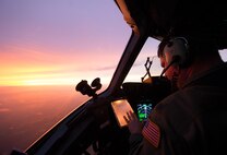 U.S. Air Force Lt. Col. Matthew Yaun, a pilot assigned to the 300th Airlift Squadron, conducts aerial operations during a training flight on-board a C-17 Globemaster III near Joint Base Charleston, S.C., Sept. 8, 2014. Training flights are vital to the operational success of Air Force personnel because they help develop the necessary skills for combat and humanitarian missions. (U.S. Air Force photo by Tech. Sgt. Barry Loo/released)