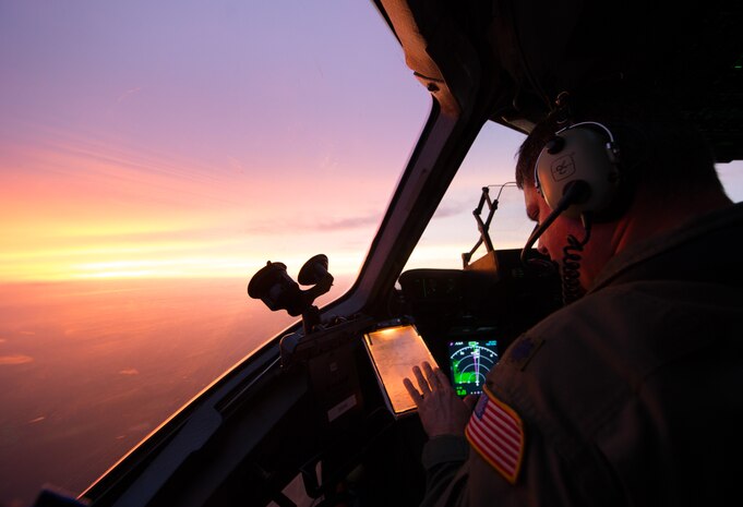 U.S. Air Force Lt. Col. Matthew Yaun, a pilot assigned to the 300th Airlift Squadron, conducts aerial operations during a training flight on-board a C-17 Globemaster III near Joint Base Charleston, S.C., Sept. 8, 2014. Training flights are vital to the operational success of Air Force personnel because they help develop the necessary skills for combat and humanitarian missions. (U.S. Air Force photo by Tech. Sgt. Barry Loo/released)