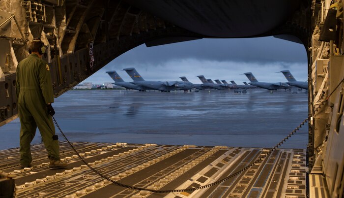 U.S. Air Force Senior Master Sgt. Phillip Johnson, a loadmaster assigned to the 300th Airlift Squadron, conducts backing procedures prior to a training flight on-board a C-17 Globemaster III at Joint Base Charleston - Air Base, S.C., Sept. 8, 2014. Training flights are vital to the operational success of Air Force personnel because they help develop the necessary skills for combat and humanitarian missions. (U.S. Air Force photo by Tech. Sgt. Barry Loo/released)