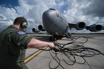 U.S. Air Force Airman 1st Class Blake Clements, a loadmaster assigned to the 17th Airlift Squadron, completes pre-flight checklist tasks prior to a training flight on-board a C-17 Globemaster III at Joint Base Charleston, S.C., Sept. 4, 2014. Training flights are vital to the operational success of Air Force personnel because they help develop the necessary skills for combat and humanitarian missions. (U.S. Air Force photo by Tech. Sgt. Barry Loo/Released)