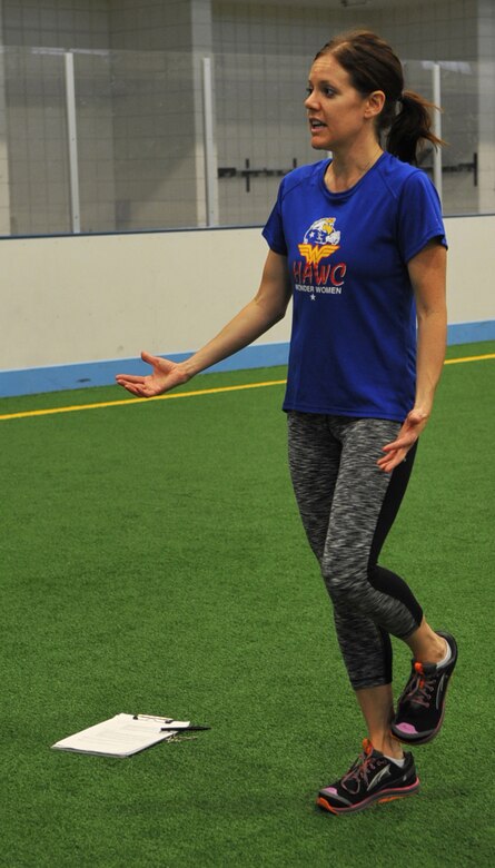 Leah Melquist, Health and Wellness Center health promotion manager, teaches students attending the running clinic the role balance plays while practicing proper running form Sept. 2, 2014, on Grand Forks AFB, N.D. Melquist demonstrated various exercises that strengthen the muscles while running. (U.S. Air Force photo/Airman 1st Class Bonnie Grantham)