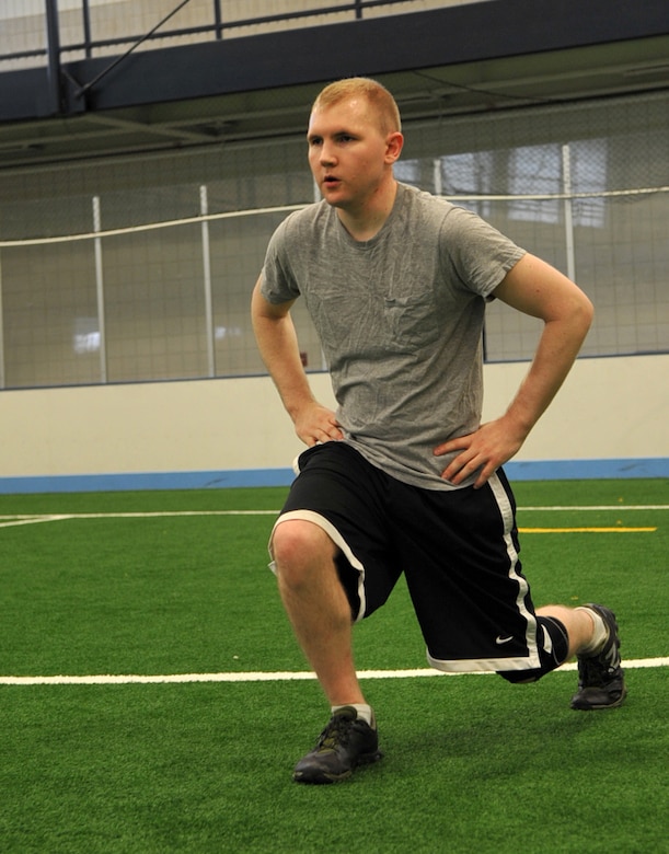 Senior Airman Morgan Mesa, 69th Reconnaisance Group aircraft structural maintenance apprentice, performs lunges during the running clinic at Grand Forks Air Force Base, N.D., Sept. 2, 2014. It is important strengthen the lower body through exercises such as lunges in order to run without the risk of injury. (U.S. Air Force photo/Airman 1st Class Bonnie Grantham)