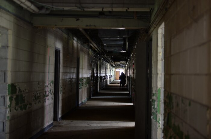 Members of the 1st Combat Camera Squadron clear an abandoned school for weapons tactics training, June 6, 2014, Bowman, S.C. Airmen with 1 CTCS practice weapons manipulation skills often to keep a combat readiness mindset at all times. (U.S. Air Force photo by Senior Airman Logan Brandt/released)