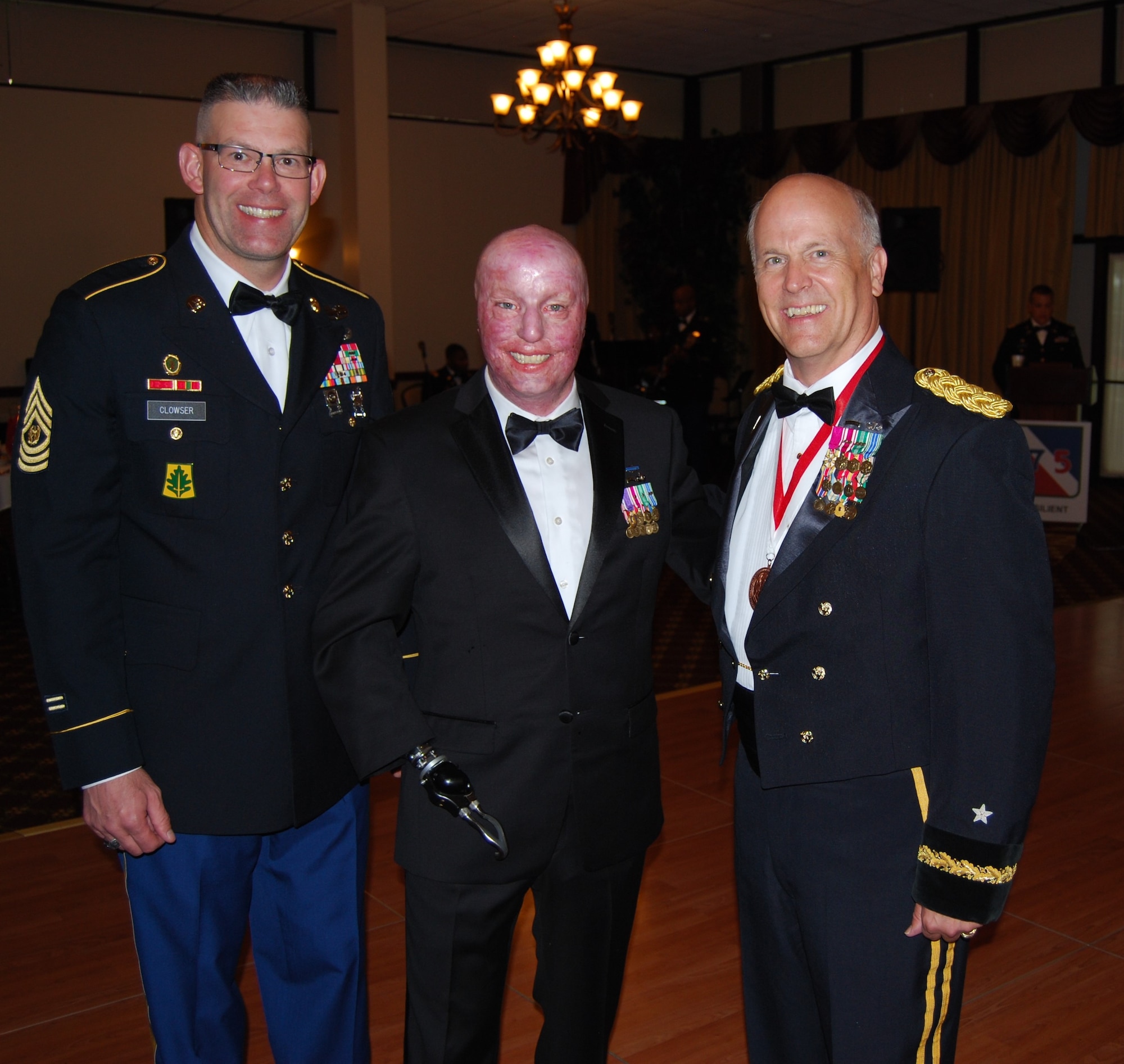Command Sgt. Maj. Richard C. Clowser, Atlantic Training Division, 75th Training Command, and Brig. Gen. John H.H. Turner III, division commander, stand with guest speaker Sgt. 1st Class Michael Schlitz (Ret.) at the Division’s dining-out at Joint Base McGuire-Dix-Lakehurst, N.J., Sept. 6, 2014. (U.S. Army photo by Lt. Col. Daniel F. McLaughlin/Released)