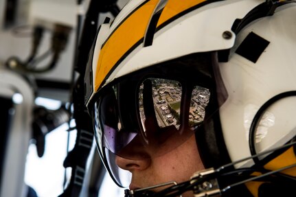 Trooper Michael McCloskey, Maryland State Police flight medic, scans the area for a vehicle that matches a description during a law enforcement mission, June 16, 2014 in Baltimore, Md. The Maryland Aviation command provides, airborne law enforcement, search and rescue, and was the first civilian agency to transport a crucially injured patient by helicopter. These medevac services are provided free of charge to patients in the state of Maryland.(U.S. Air Force photo by Staff Sgt. Perry Aston/released)