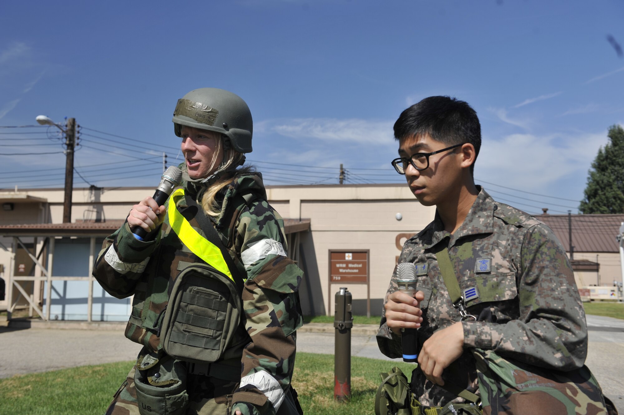 Master Sgt. Thomas Longworth, 51st Civil Engineering Squadron commander inspection program manager, left, holds a container as Republic of Korea air force Senior Airman Jo Hang Sun, ROKAF reconnaissance rapid response team member, places a simulated biological chemical into it during a simulated biological response training event on Osan Air Base, ROK, Sept. 16, 2014. The U.S. Airmen demonstrated how they deploy to a scene, pull a sample and transport it to a laboratory for further analysis. (U.S. Air Force photo by Senior Airman David Owsianka)