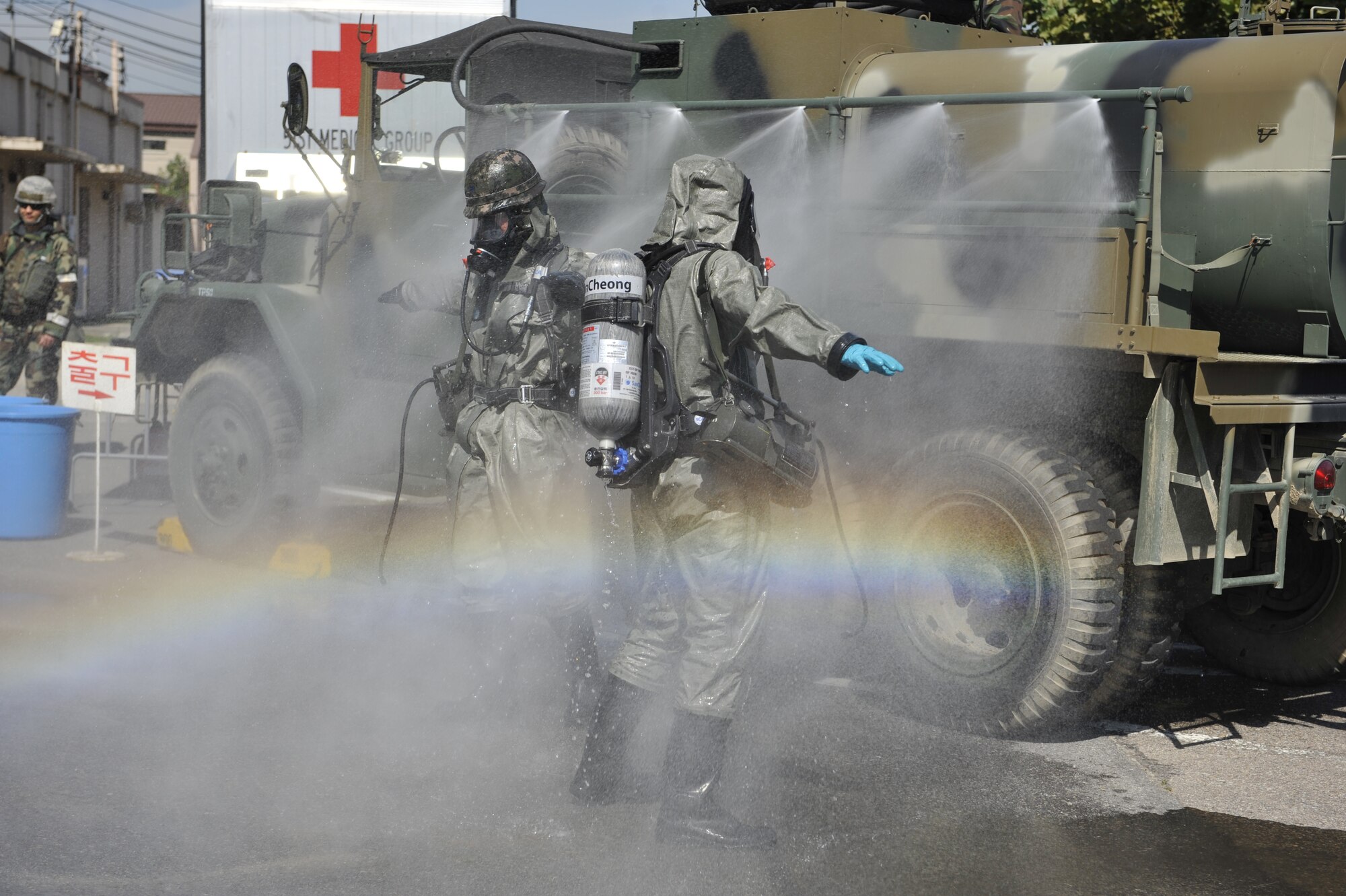 Members of the Republic of Korea air force wash off at a decontamination site after checking for biological samples in a contaminated area during a simulated biological response training event on Osan Air Base, ROK, Sept. 16, 2014. The ROKAF and U.S. Air Force worked together to improve their mission capability. (U.S. Air Force photo by Senior Airman David Owsianka)