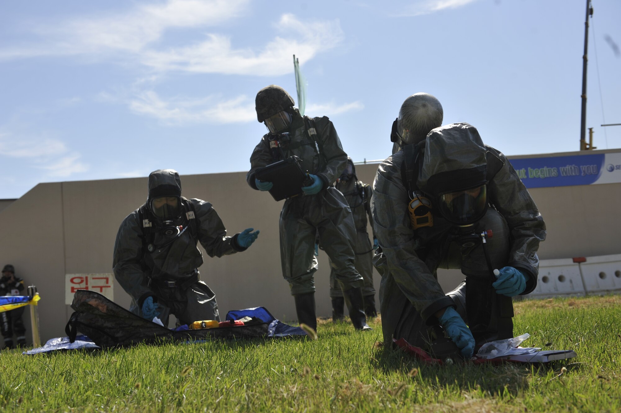 Members of the Republic of Korea air force set up their gear to sample a simulated biological chemical during a simulated biological response training event on Osan Air Base, ROK, Sept. 16, 2014. The ROKAF airmen demonstrated their capabilities by pulling a sample, decontaminating the area and then decontaminating the personnel. (U.S. Air Force photo by Senior Airman David Owsianka)
