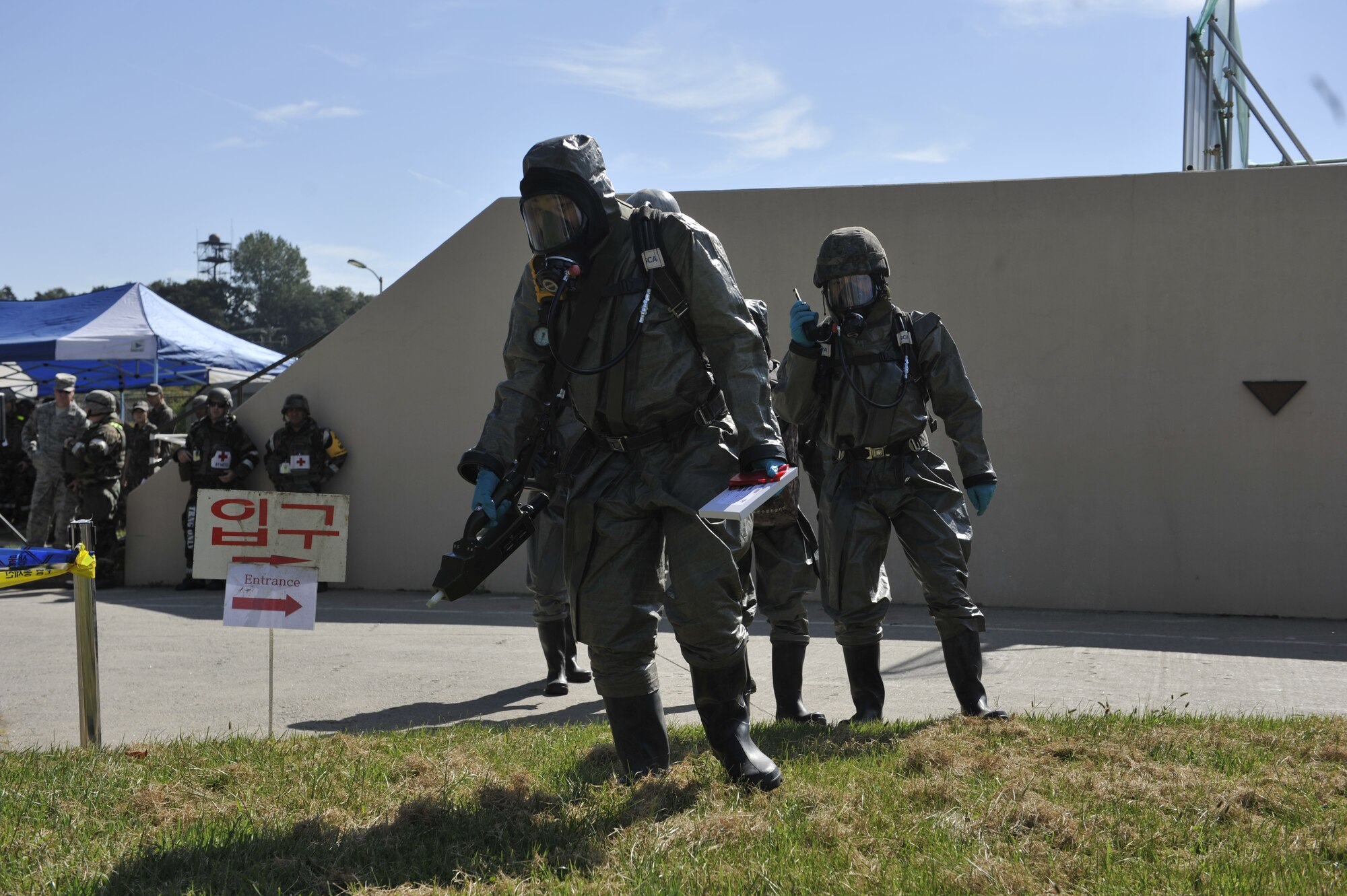Members of the Republic of Korea air force walk onto a simulated contaminated area during a simulated biological response training event on Osan Air Base, ROK, Sept. 16, 2014. The ROKAF airmen demonstrated their capabilities by pulling a sample, decontaminating the area and then decontaminating the personnel. (U.S. Air Force photo by Senior Airman David Owsianka)
