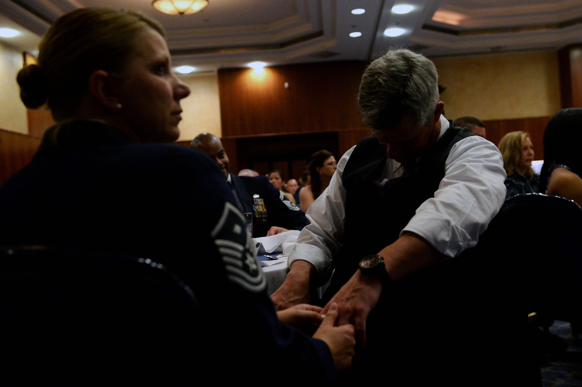 U.S. Air Force Master Sgt. Stacy Warner, left, 606th Air Control Squadron first sergeant from St. Louis, comforts her husband, Brian, 52nd Logistic Readiness Squadron unit program coordinator from New Haven, Conn., during the “Every Airman Has a Story” reading at the 2014 Air Force Ball in Club Eifel at Spangdahlem Air Base, Germany, Sept. 13, 2014. “The American Airman” served as the guest speaker for the ball, and Spangdahlem Airmen read fictional letters from five different eras in Air Force history. (U.S. Air Force photo by Airman 1st Class Timothy Kim/Released)