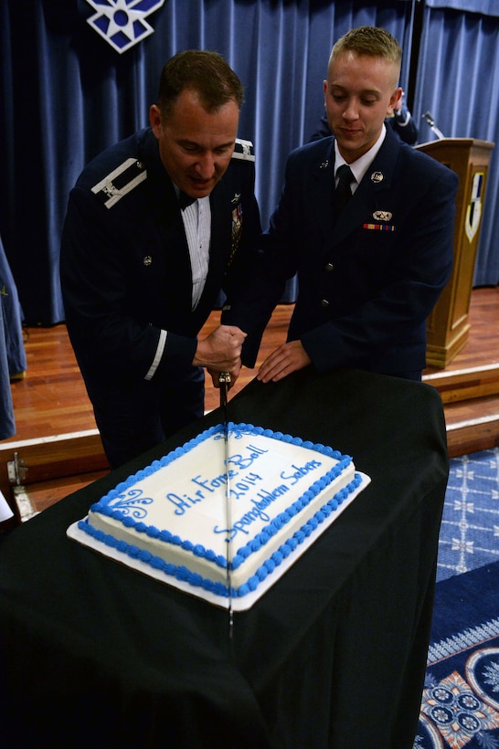U.S. Air Force Col. Pete Bilodeau, left, 52nd Fighter Wing commander, and U.S. Air Force Airman Basic Trevor Hume Wolanske, a vehicle operator from the 52nd Logistics Readiness Squadron, cut the cake in commemoration of the Air Force’s 67th birthday during the Air Force Ball in Club Eifel at Spangdahlem Air Base, Germany, Sept. 13, 2014. Bilodeau and Hume Wolanske, as both the installation’s most senior-ranking and junior-ranking Airmen, respectively, cut the cake per Air Force tradition. (U.S. Air Force photo by Airman 1st Class Timothy Kim/Released)