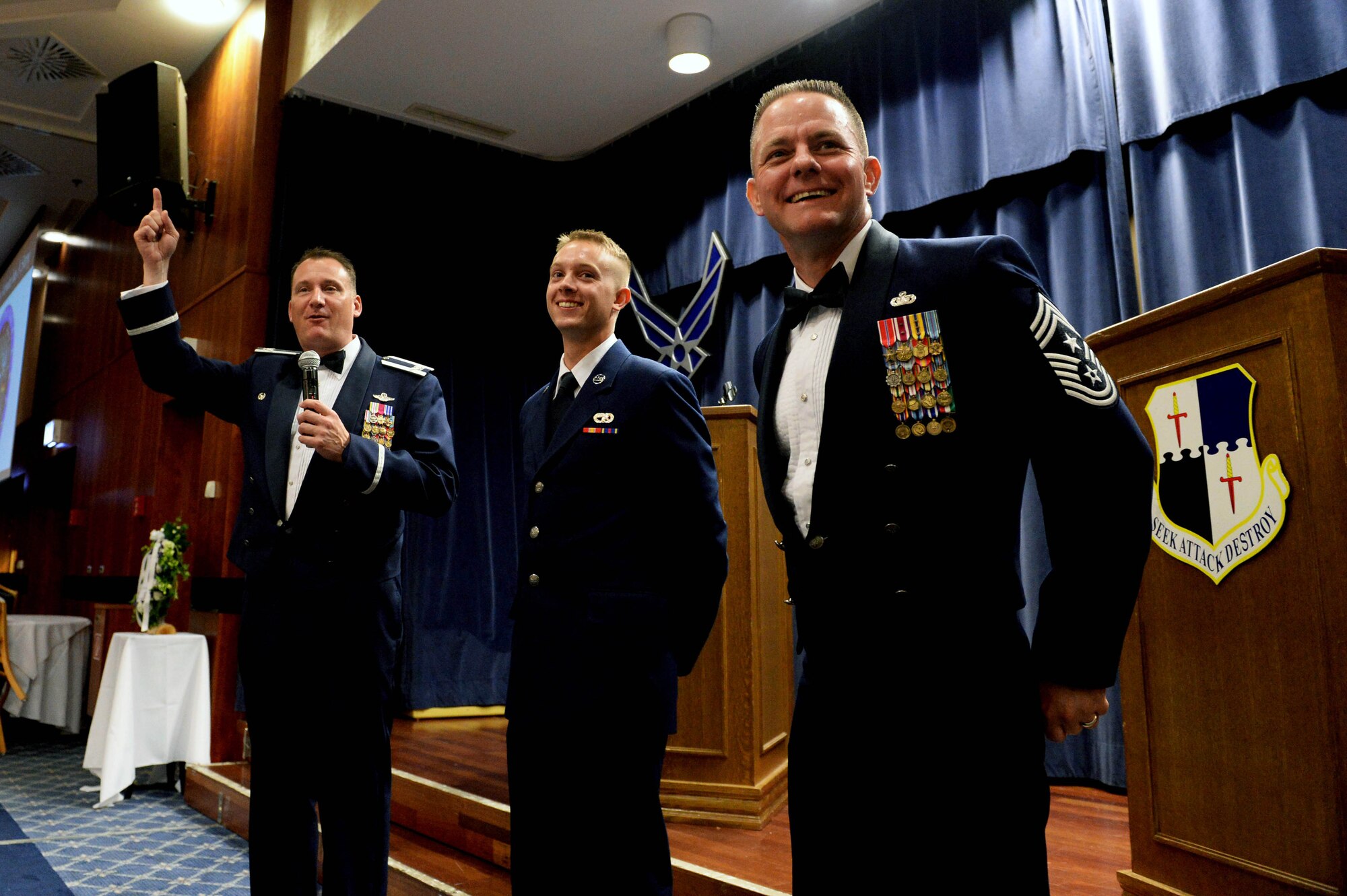 U.S. Air Force Col. Pete Bilodeau, left, 52nd Fighter Wing commander, and U.S. Air Force Chief Master Sgt. Brian Gates, right, 52nd FW command chief, introduce U.S. Air Force Airman Basic Trevor Hume Wolanske, center, a 52nd Logistics Readiness Squadron vehicle operator, as the installation’s youngest Airman during the Air Force Ball in Club Eifel at Spangdahlem Air Base, Germany, Sept. 13, 2014. The most senior-ranking Airman and the most junior-ranking Airman cut the Air Force birthday cake, according to Air Force Ball tradition. (U.S. Air Force photo by Airman 1st Class Timothy Kim/Released)