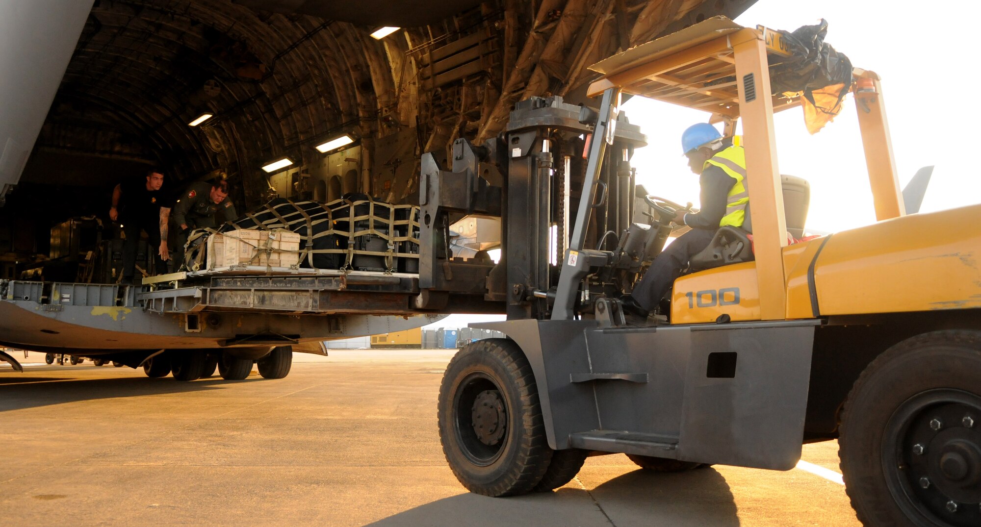 Airmen and Soldiers unload cargo from a C-17 Globemaster III Sept. 15, 2014, after landing at Waterkloof Air Force Base, Pretoria, South Africa. The aircraft and crew are part of the United States presence at the Africa Aerospace & Defence Expo 2014, along with the U.S. Army's Golden Knights parachute demonstration team, U.S. Air Forces in Europe band Wings of Dixie and a C-130J Super Hercules from Ramstein Air Base, Germany. (U.S. Air Force photo by Tech. Sgt. Austin M. May/Released)