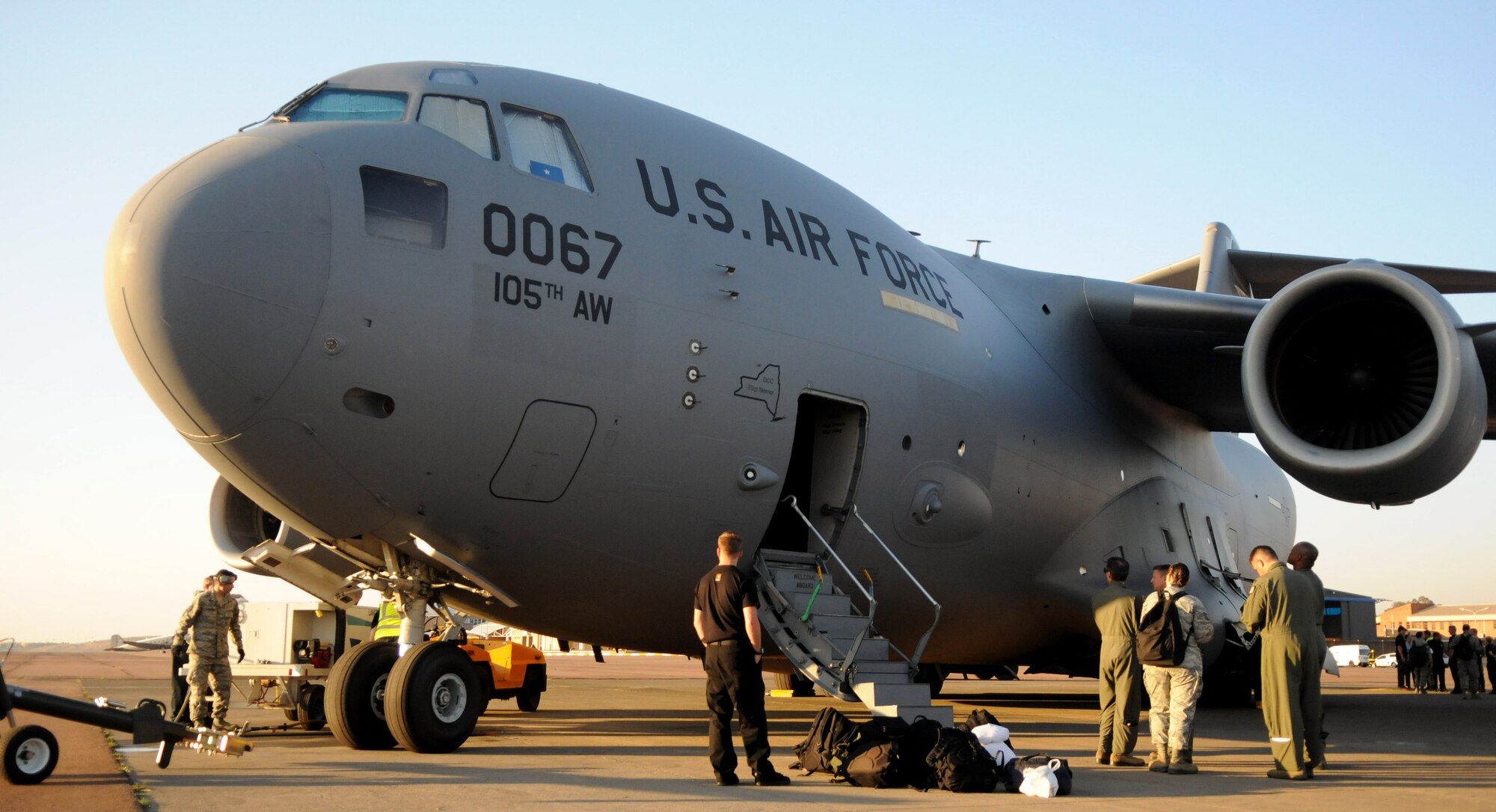 Air and ground crews perform post-flight procedures on a New York Air National Guard C-17 Globemaster III Sept. 15, 2014, after landing at Waterkloof Air Force Base, Pretoria, South Africa. The aircraft and crew are part of the United States presence at the Africa Aerospace & Defence Expo 2014, along with the U.S. Army's Golden Knights parachute demonstration team, U.S. Air Forces in Europe band Wings of Dixie and a C-130J Super Hercules from Ramstein Air Base, Germany. (U.S. Air Force photo by Tech. Sgt. Austin M. May/Released)