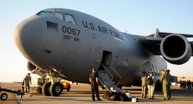 Air and ground crews perform post-flight procedures on a New York Air National Guard C-17 Globemaster III Sept. 15, 2014, after landing at Waterkloof Air Force Base, Pretoria, South Africa. The aircraft and crew are part of the United States presence at the Africa Aerospace & Defence Expo 2014, along with the U.S. Army's Golden Knights parachute demonstration team, U.S. Air Forces in Europe band Wings of Dixie and a C-130J Super Hercules from Ramstein Air Base, Germany. (U.S. Air Force photo by Tech. Sgt. Austin M. May/Released)