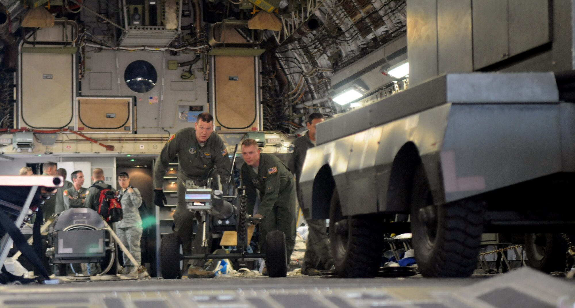 Aircrew from the 105th Airlift Wing, New York Air National Guard, prepare to unload cargo from a C-17 Globemaster III Sept. 15, 2014, after landing at Waterkloof Air Force Base, Pretoria, South Africa. The aircraft and crew are part of the United States presence at the Africa Aerospace & Defence Expo 2014, along with the U.S. Army's Golden Knights parachute demonstration team, U.S. Air Forces in Europe band Wings of Dixie and a C-130J Super Hercules from Ramstein Air Base, Germany. (U.S. Air Force photo by Tech. Sgt. Austin M. May/Released)