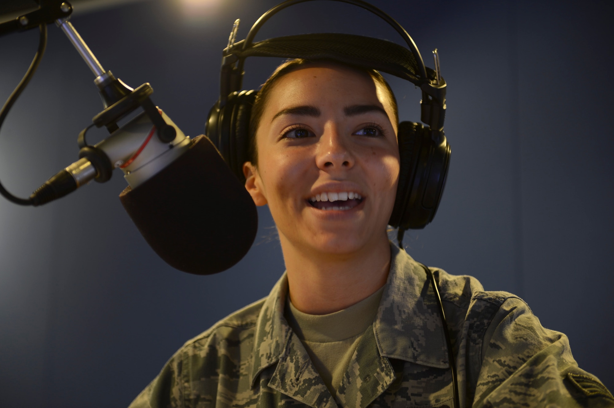 Senior Airman Courtney Graffius, American Forces Network Kaiserslautern broadcast journalist, DJs a radio morning show on Vogelweh Military Complex, Sept. 10, 2014. AFN Kaiserslautern consists of Airmen and soldiers working together to inform and update a multi-service community on the things happening around them. (U.S. Air Force photo/Airman 1st Class Michael Stuart)
