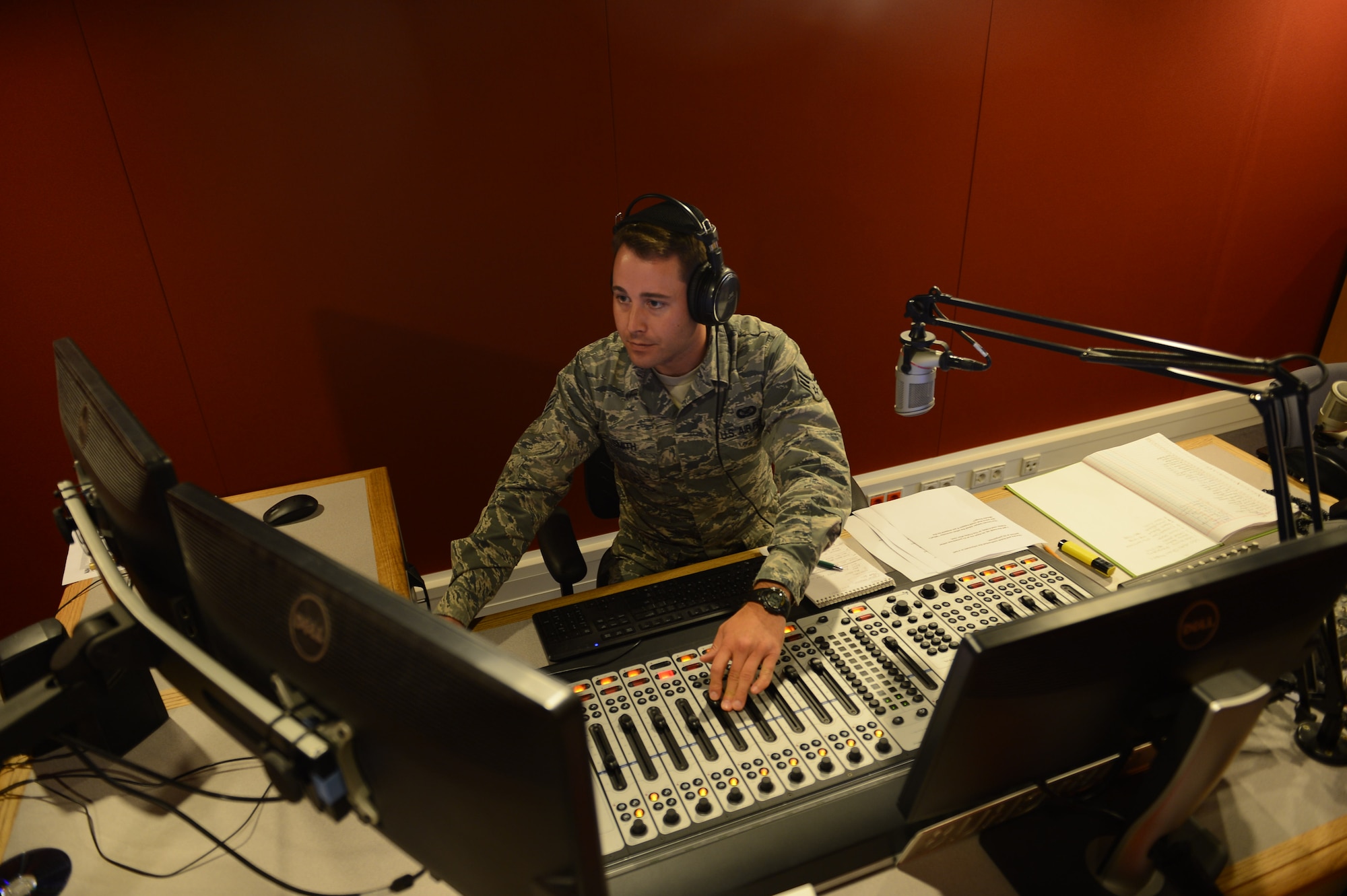 Senior Airman Eli Smith, American Forces Network Kaiserslautern broadcast journalist, DJs a radio morning show on Vogelweh Military Complex, Sept. 10, 2014. The American Forces Network, Kaiserslautern, has been providing service to military members since 1954 while bringing with them a taste of home. (U.S. Air Force photo/Airman 1st Class Michael Stuart)