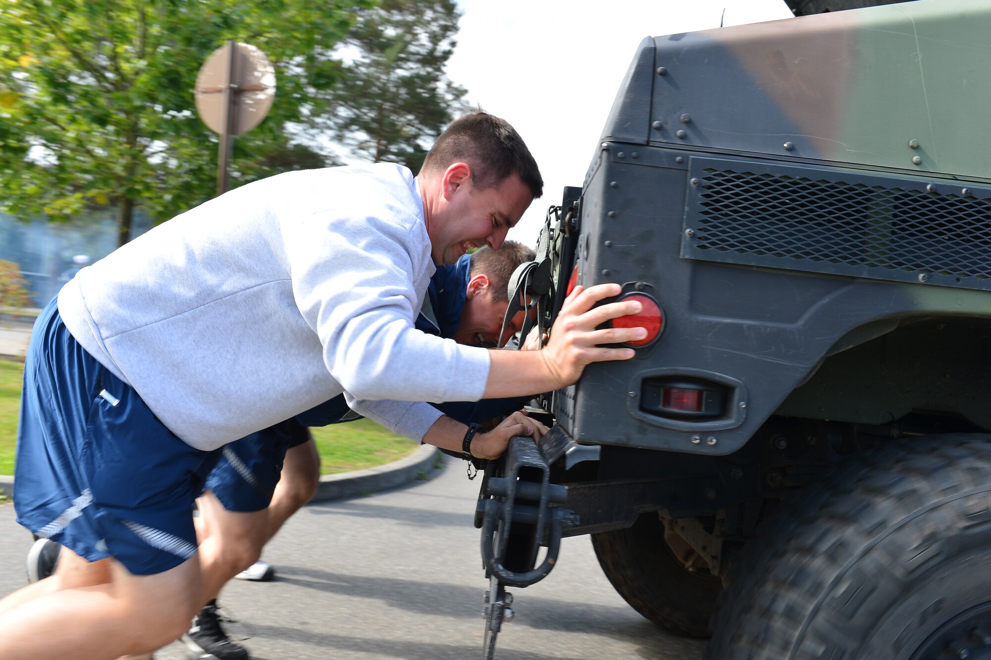 The 86th Aeromedical Support Squadron team pushes a Humvee to the finish line during Resilience Day on Ramstein Air Base, Germany, Sept. 11, 2014.  This year's Resilience Day featured a commander's challenge compiled of athletic events to challenge Airmen.  The challenge included; 3-on-3 basketball tournament, 6-on-6 volleyball match, dodge ball, soccer, 1 pitch softball, 1 pitch kickball, 7-on-7 flag football, hula-hoop competition, 3 legged race, 400M tricycle team relay, Humvee push, tug-of-war, golf challenge and concluded with a Colonels vs. Chiefs softball game.  (U.S. Air Force photo/Tech. Sgt. Daylena S. Ricks)