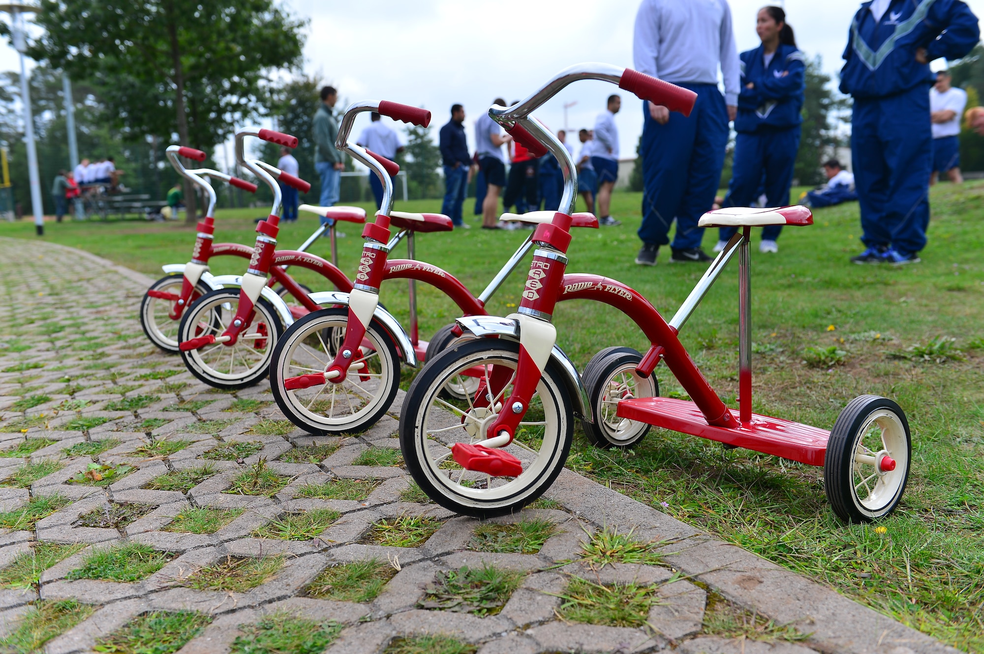 Tricycles await riders during Resilience Day on Ramstein Air Base, Germany, Sept. 11, 2014.  This year's Resilience Day featured a commander's challenge compiled of athletic events to challenge Airmen.  The challenge included; 3-on-3 basketball tournament, 6-on-6 volleyball match, dodge ball, soccer, 1 pitch softball, 1 pitch kickball, 7-on-7 flag football, hula-hoop competition, 3 legged race, 400M tricycle team relay, Humvee push, tug-of-war, golf challenge and concluded with a Colonels vs. Chiefs softball game.  (U.S. Air Force photo/Tech. Sgt. Daylena S. Ricks)