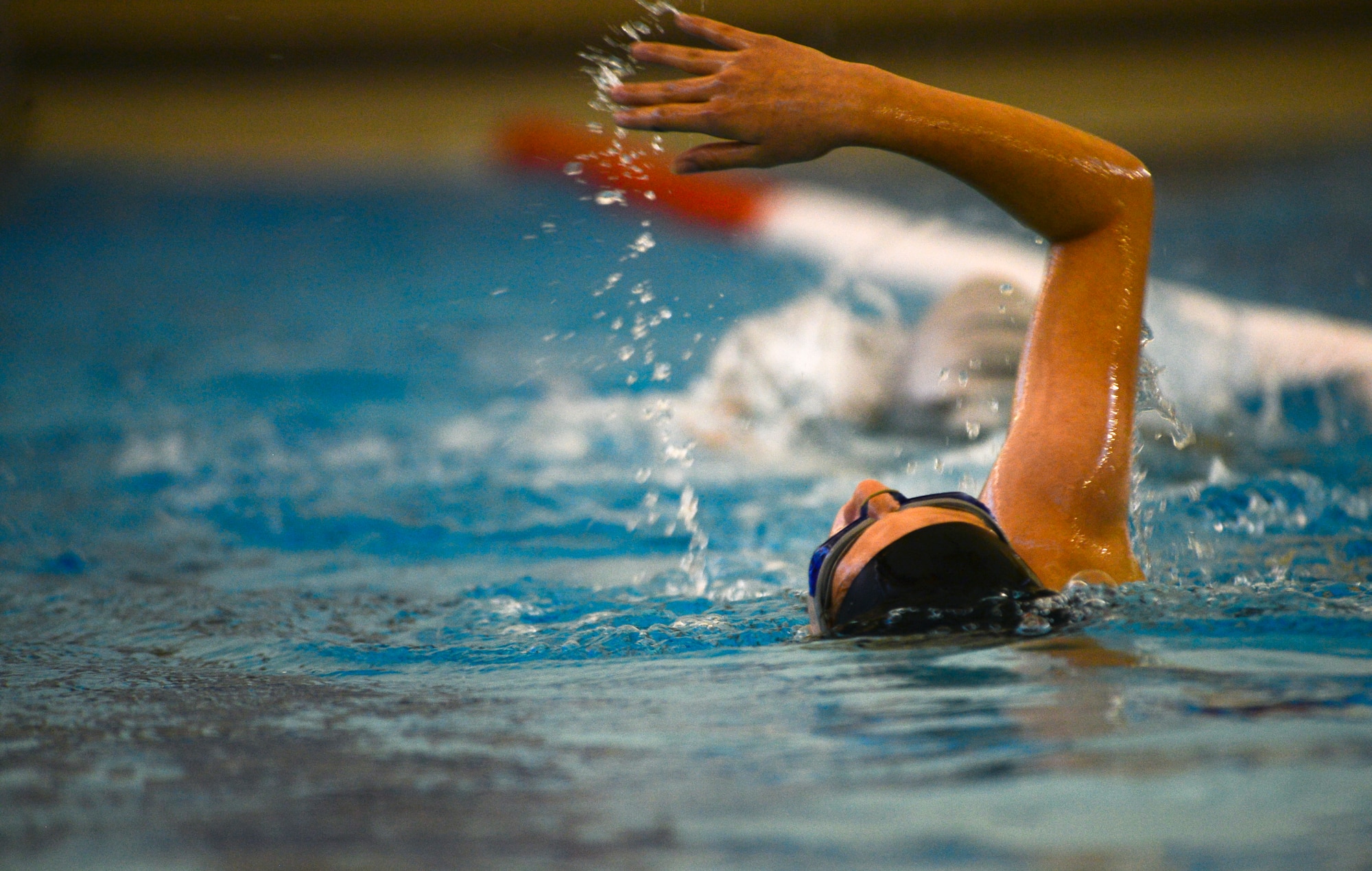 A swimmer from the Lakenheath Barracudas swim team performs a backstroke during practice at Royal Air Force Honington, England, Sept. 4, 2014. The European Forces Swim League is comprised of American and British swimmers who attend weekly practices and compete against other EFSL teams around the European region. (U.S. Air Force photo by Airman 1st Class Erin O’Shea/Released)  