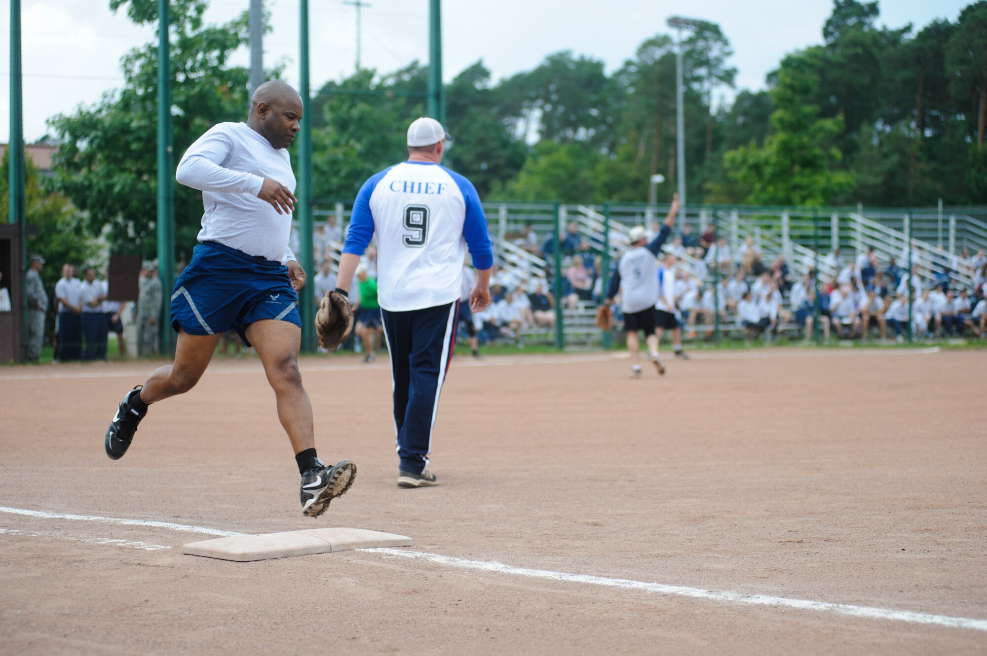 Col. Lawrence Hicks, 86th Logistics Group commander, runs to first base during an outfield hit Sep. 11, 2014, at Ramstein Air Base, Germany. Hicks was part of the RUfit Resilience Day chiefs vs eagles game.  (U.S. Air Force photo/ Senior Airman Timothy Moore)