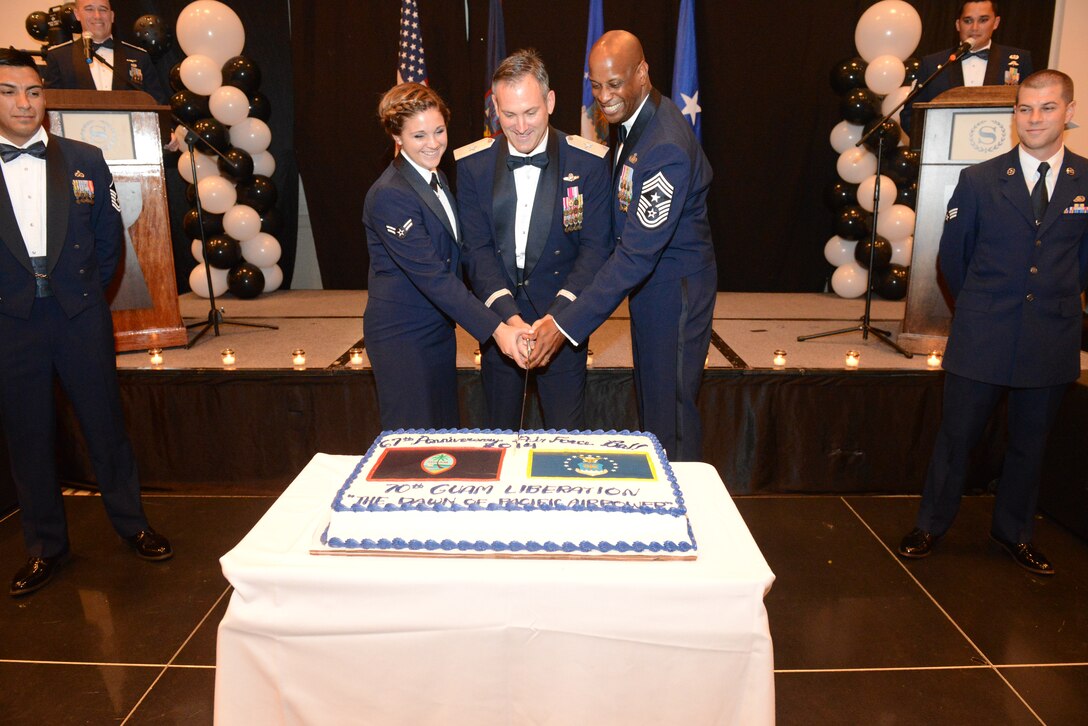 Airman 1st Class Hannah Walsh Brig. Gen. Andrew J. Toth is Commander, 36th Wing, and Guam Chief Master Sgt. Michael A. McMillan,36th Wing, Command Chief, cut the Air Force birthday cake at the 67th Annual Air Force Ball Sept 13, 2014, at The Sheraton Hotel in Tumon, Guam. Cake cutting rituals feature the oldest Airman present cutting the cake with the youngest airman present. (U.S. Air Force Photo by Airman 1st Class Adarius Petty/Released)
