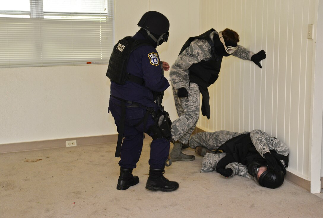 A Department of Navy security member attempts to stop a domestic dispute during training, Sept. 11, 2014, on Andersen Air Force Base, Guam. The defenders trained on clearing houses, handling noise and domestic calls as well as suicidal situations to maintain currency. (U.S. Air Force photo by Staff Sgt. Robert Hicks/Released)