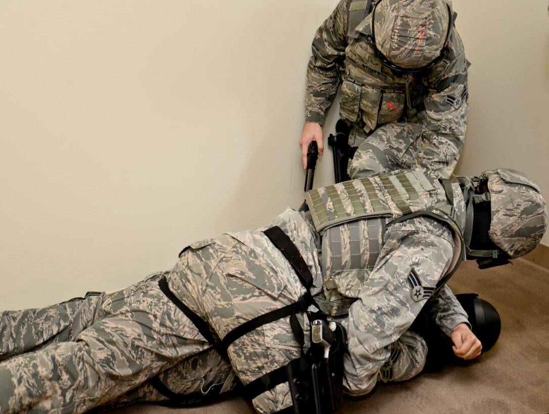 Members from the 36th Security Forces Squadron take down the opposing force during a suicide scenario, Sept. 11, 2014, on Andersen Air Force Base, Guam. The defenders trained on clearing houses, handling noise and domestic calls as well as suicidal situations to maintain currency. (U.S. Air Force photo by Staff Sgt. Robert Hicks/Released)