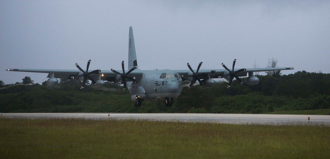 A KC-130J Super Hercules lands on a runway during Exercise Valiant Shield 2014 Sept. 15 on Tinian's West Field. Valiant Shield is a biennial, U.S.-only, exercise with focus on integration of joint training among U.S. forces. The C-130 is with Marine Aerial Refueler Transport Squadron 152, Marine Aircraft Group 12, 1st Marine Aircraft Wing, III Marine Expeditionary Force.(U.S. Marine Corps photo by Lance Cpl. Austin Schlosser/Released)