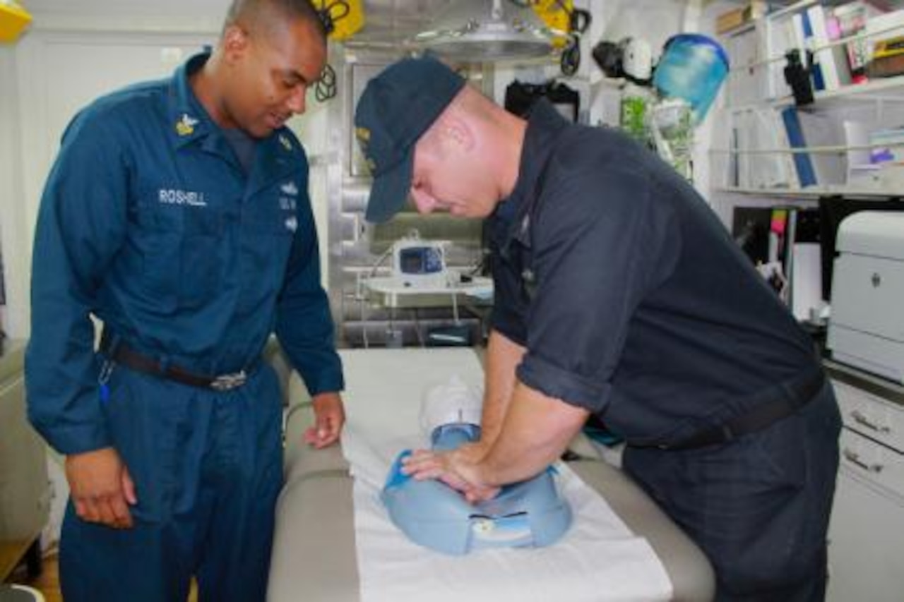 Navy Petty Officer 1st Class Jerry Roshell, left, a hospital corpsman from Milwaukee, instructs Petty Officer 2nd Class Nicholas Dunn, from Bangor, Maine, on proper CPR technique aboard the Arleigh Burke-class guided-missile destroyer USS Stethem. Stethem is on patrol in the 7th Fleet area of operations supporting security and stability in the Indo-Asia-Pacific region. U.S. Navy photo by Ensign Rebecca Speer
