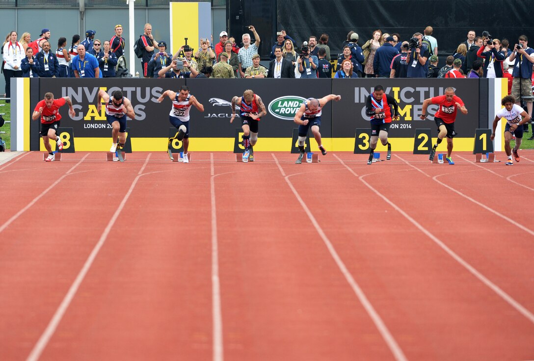Competitors leave the starting blocks during a 100-meter race at the Invictus Games in London, Sept. 11, 2014. The international competition was held Sept. 10-14, bringing together wounded, injured and ill service members in the spirit of friendly athletic competition. A group of 98 current and retired service members represented the U.S.