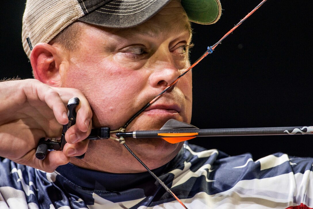 U.S. Marine Corps Maj. Richard Burkett pulls back an arrow during a gold medal archery match against Canada’s Cpl. Luc Martin at the Invictus Games in London, Sept. 12, 2014. Burkett won the gold medal in the mixed individual compound bow category. More than 400 competitors from 13 nations took part in the inaugural Invictus Games, a multisport event for wounded and injured service members held Sept. 10-14. Organizers said the vision for the Invictus Games is to harness the power of sport to inspire recovery, support rehabilitation and generate a wider understanding and respect for those who serve their country.