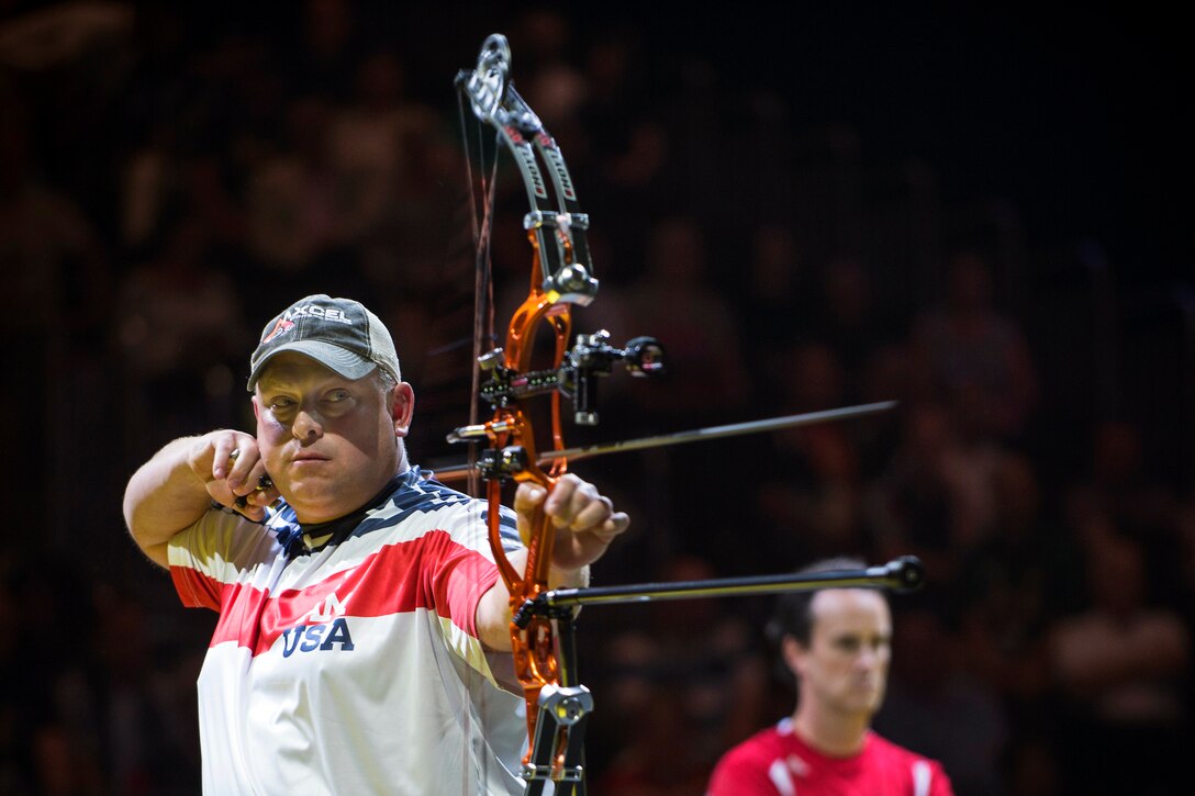 U.S. Marine Corps Maj. Richard Burkett releases an arrow during the mixed individual compound bow gold medal match at the Invictus Games in London, Sept. 12, 2014. 