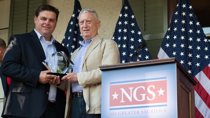 Retired Gen. James Mattis is presented the Freedom Award by Marine veteran Jeremiah Workman at the No Greater Sacrifice 2014 Freedom Award Family Day, Washington D.C., September 13, 2014. The Freedom Award is awarded to a service member who gives in selfless service to their nation. (U.S. Marine Corps photo by Sgt. Melissa Karnath/Released)