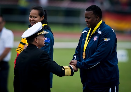 After placing first in the women’s IF2 shot put at the Invictus Games, retired U.S. Army Sgt. Monica Southall is congratulated by Navy Adm. James A. Winnefeld Jr., vice chairman of the Joint Chiefs of Staff, during the medal ceremony at the Lee Valley Athletics Centre Sept. 11, 2014, in London.