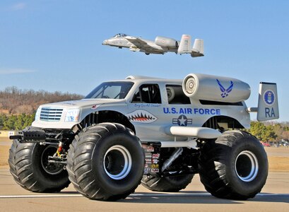 An A-10C Thunderbolt II "Warthog" piloted by Lt. Col. Tim Eddins of the 188th Fighter Wing of the Arkansas Air National Guard conducts a low approach over an A-10 monster truck above the runway at the Fort Smith (Ark.) Regional Airport during a photo and video shoot with U.S. Air Force Recruiting Services Jan. 26, 2010. 