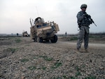 Spc. Tommy J. Thomason Jr., a gunner with 3rd Platoon, 204th Military Police Company, 519th MP Battalion, headquartered in Fort Polk, La., stands security while awaiting Q-West's vehicle recovery quick reaction force to arrive and extract a Mine-Resistant, Ambush-Protected gun truck mired in a sinkhole in Ninewa Province, Jan. 18, 2010. The recovery QRF - manned by C Company, 2nd Battalion, 198th Combined Arms, 155th Brigade Combat Team of the Mississippi National Guard - retrieved the vehicle and returned it to base.