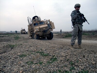 Spc. Tommy J. Thomason Jr., a gunner with 3rd Platoon, 204th Military Police Company, 519th MP Battalion, headquartered in Fort Polk, La., stands security while awaiting Q-West's vehicle recovery quick reaction force to arrive and extract a Mine-Resistant, Ambush-Protected gun truck mired in a sinkhole in Ninewa Province, Jan. 18, 2010. The recovery QRF - manned by C Company, 2nd Battalion, 198th Combined Arms, 155th Brigade Combat Team of the Mississippi National Guard - retrieved the vehicle and returned it to base.