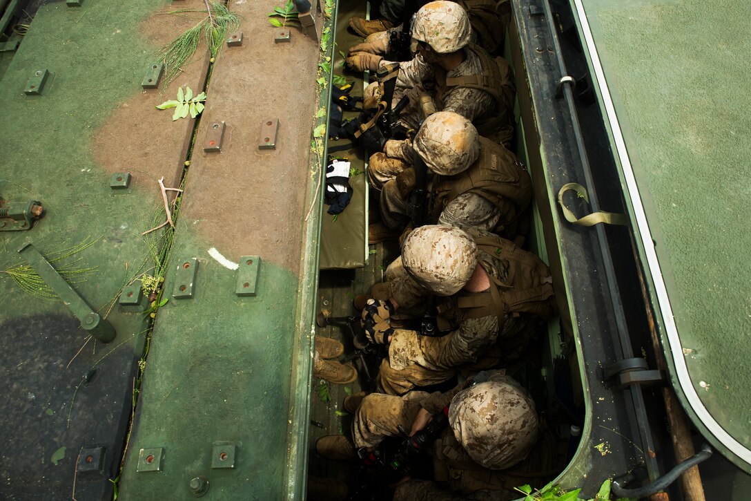 Marines assigned to Golf Company, 2nd Battalion, 3rd Marine Regiment, prepare to disembark amphibious assault vehicles to conduct a simulated raid at landing zone Boondocker, Marine Corps Base Hawaii, Sept. 16, 2014. The Marines were training in military operations in urban terrain as part of Exercise Island Viper, a staple in Hawaii Marines’ pre-deployment training cycle. (U.S. Marine Corps photo by Cpl. Matthew Callahan/Released)