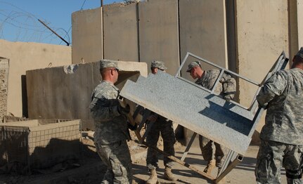 Force Protection Soldiers of Bravo Troop with the Colorado National Guard's 41st Infantry Brigade Combat Team, move stairs of an observation point at an entry control point to Victory Base Complex on Jan. 9, 2010. The entry point was upgraded to provide more security for VBC. Blast walls were added around the entrance. Hesco barriers were replaced and added to support the base of the observation point.