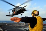 An HH-60G Pave Hawk helicopter from the Alaska Air National Guard 210th Rescue Squadron performs deck landing qualifications aboard the forward-deployed guided-missile cruiser USS Shiloh during preparations for Hong Kong Search and Rescue Exercise 2008. Rescuers  used a similar craft to save three plane crash victims.