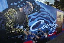 The U.S. Marine Corps mural at Hyde Park's Kelley Field is photographed May 7, 2010, in Boston. A team of combat camera Marines and Gregg Bernstein, from the Boston mayor's mural crew, created the Marine-designed mural during a community outreach project for Marine Week Boston May 3-9. (U.S. Marine Corps photo by Staff Sgt. Michael A. Blaha/Released)