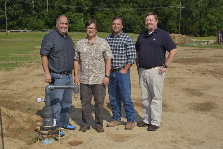 The ERDC Environmental Laboratory’s  Environmental Security Engineering Team, pictured from left,  Dr. Victor Medina, Scott Waisner and far right, Chris Griggs, is joined by Tony King, second from right, site preparation coordinator for the Directorate of Public Works at the test pipe location on ERDC Vicksburg’s campus. The team is testing two water leak detection systems for a DoD Environmental Security Testing Certification Program  project. 