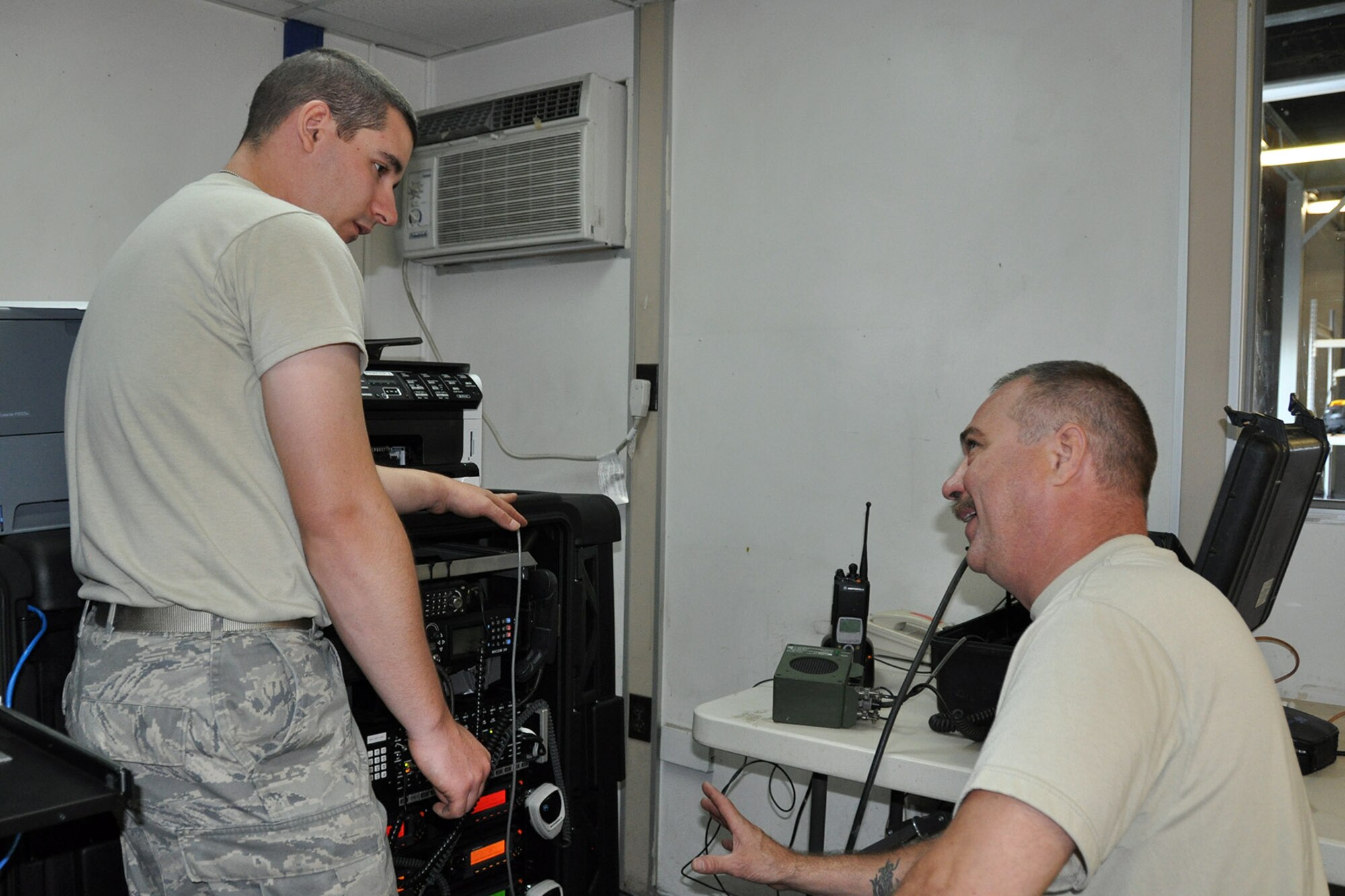 Air Force Reserve Staff Sgt. Gregory Mackel, a Cyber Systems Technician assigned to the 910th Communications Squadron (CS), listens as Tech. Sgt. Donald Adkins, 910th CS Radio Frequency Transmission Technician, talks with him about radio systems operations in the 910th CS work center here, Sept. 16, 2014. A five-person 910th CS team is providing support to the two-week mission through a wide variety of technologies designed to keep all of the 910th’s Citizen Airmen in touch with each other and their home base of Youngstown Air Reserve Station, Ohio while performing their duty in Idaho. The 910th Airlift Wing, based at Youngstown Air Reserve Station, Ohio, is home to the Department of Defense’s only large-area, fixed-wing aerial spray capability. U.S. Air Force photo by Master Sgt. Bob Barko Jr.
