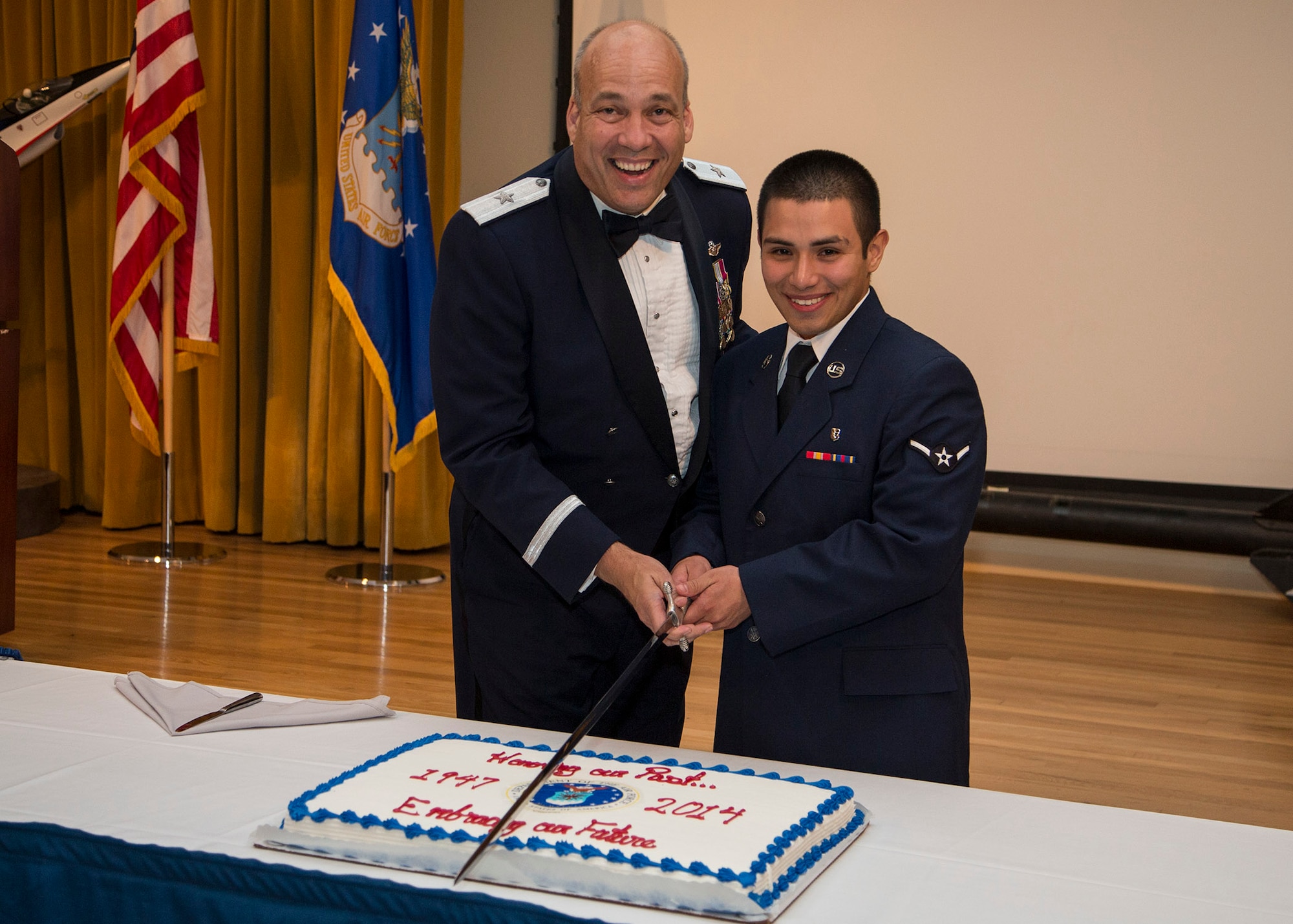 In keeping with tradition, Brig. Gen. Michael Brewer, 412th Test Wing commander and highest ranking officer attending the dinner, cuts the U.S. Air Force birthday cake with Airman Juan Bonilla, 412th Aerospace Medicine Squadron, the lowest ranking and youngest Airman in attendence. Team Edwards celebrated the Air Force's 67th birthday with a formal dinner at Club Muroc Sept. 12. The Air Force's official birthday is Sept. 18. (U.S. Air Force photo by Bobbi Zapka) 
