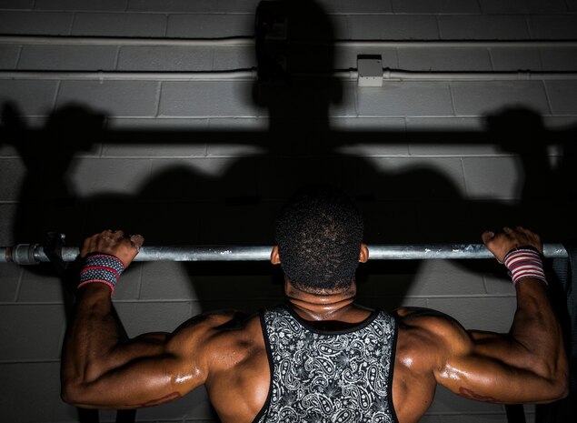 Senior Airman Jacob Allen, 437th Aircraft Maintenance Squadron crew chief, performs butterfly pull-ups during a CrossFit class Sept. 16, 2014, at the Joint Base Charleston Fitness Center. Individuals perform several repetitions of each exercise as they progress through their workout. (U.S. Air Force photo/ Senior Airman Dennis Sloan)