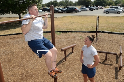 Staff Sgt. Nick Yankosky, 381st Training Squadron medical readiness instructor, and his wife Staff Sgt. Kelly Yankosky, 59th Orthopedics and Rehabilitation Squadron orthopedic technician, participate in a high interval functional training workout together Aug. 27at the Warhawk Fitness Center. These workouts are part of strength and conditioning fitness methodology that capitalizes on the theory of muscle confusion, by performing constantly varied, functional movements at high-intensity. Some of the workouts include Olympic weightlifting, kettlebells, gymnastics rings, pull-up bars, and many calisthenics exercises. (U.S. Air Force photo by Johnny Saldivar)