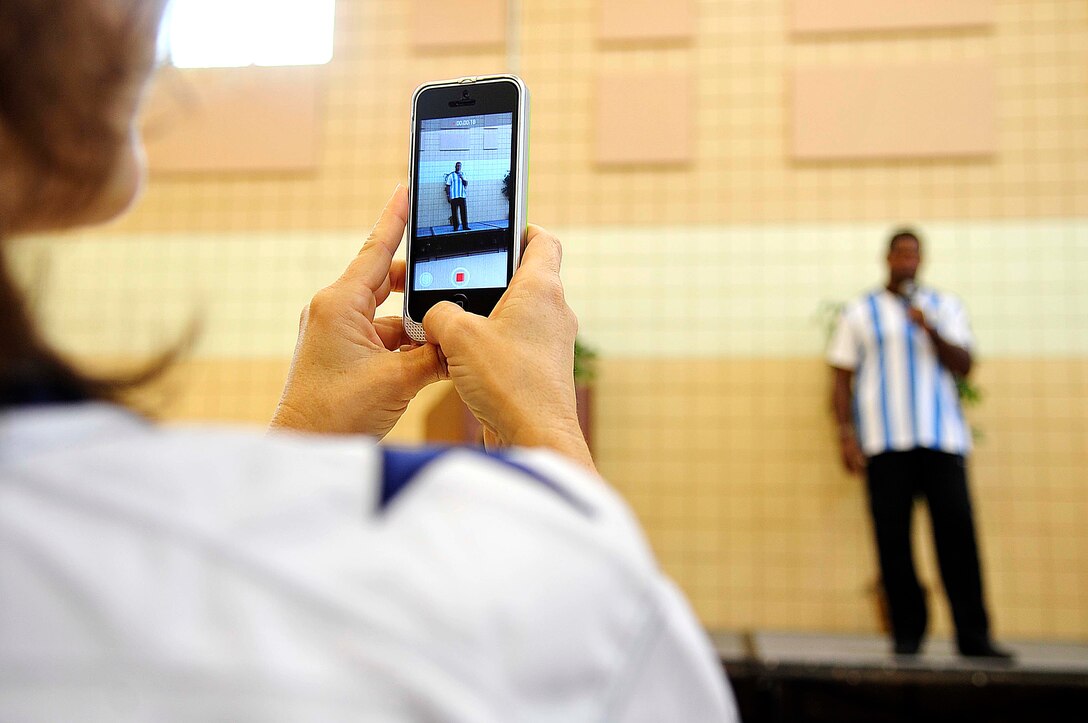 A Cowboys’ fan records Herschel Walker, Heisman Trophy recipient and mental health advocate, speech about mental health at Langley Air Force Base, Va., Sept. 17, 2014. Walker shared his main piece of advice to military members who may be battling mental health disorders, such as post-traumatic stress disorder or depression - “There is no shame for asking for help, I did.” (U.S. Air Force photo by Airman 1st Class Breonna Veal/Released)