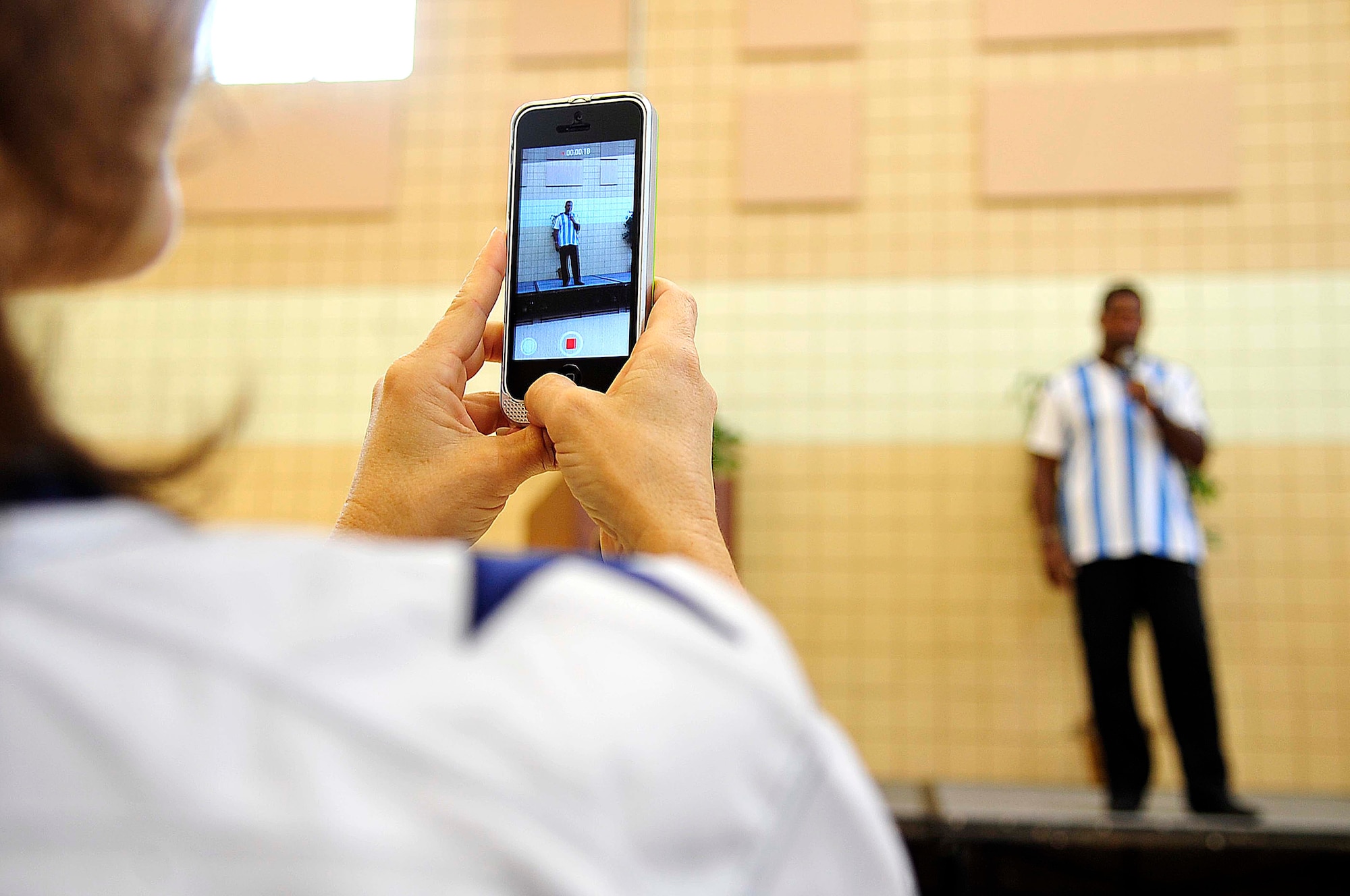 A Cowboys’ fan records Herschel Walker, Heisman Trophy recipient and mental health advocate, speech about mental health at Langley Air Force Base, Va., Sept. 17, 2014. Walker shared his main piece of advice to military members who may be battling mental health disorders, such as post-traumatic stress disorder or depression - “There is no shame for asking for help, I did.” (U.S. Air Force photo by Airman 1st Class Breonna Veal/Released)